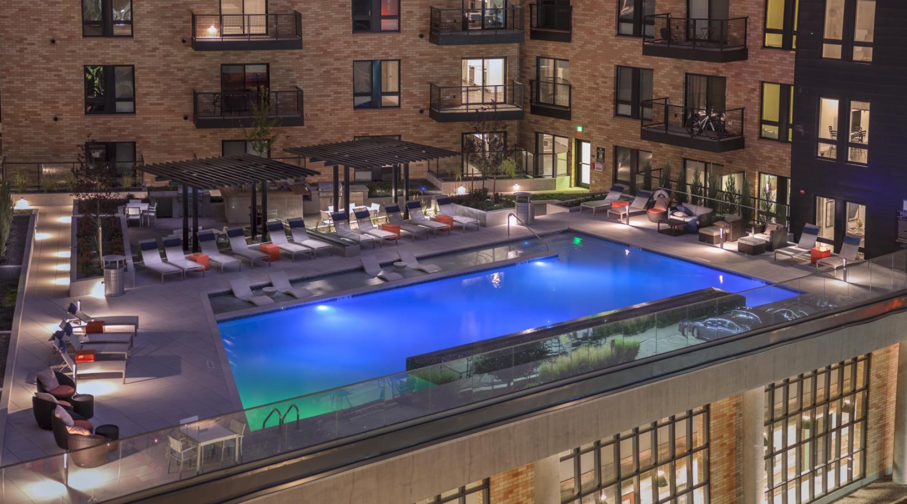 Relax and unwind poolside a swimming pool in a brick building