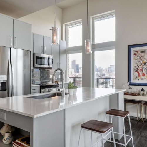 a kitchen with a bar stool and a table